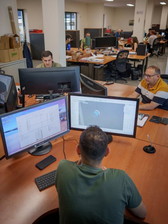 Designers at computer workstation in technical office